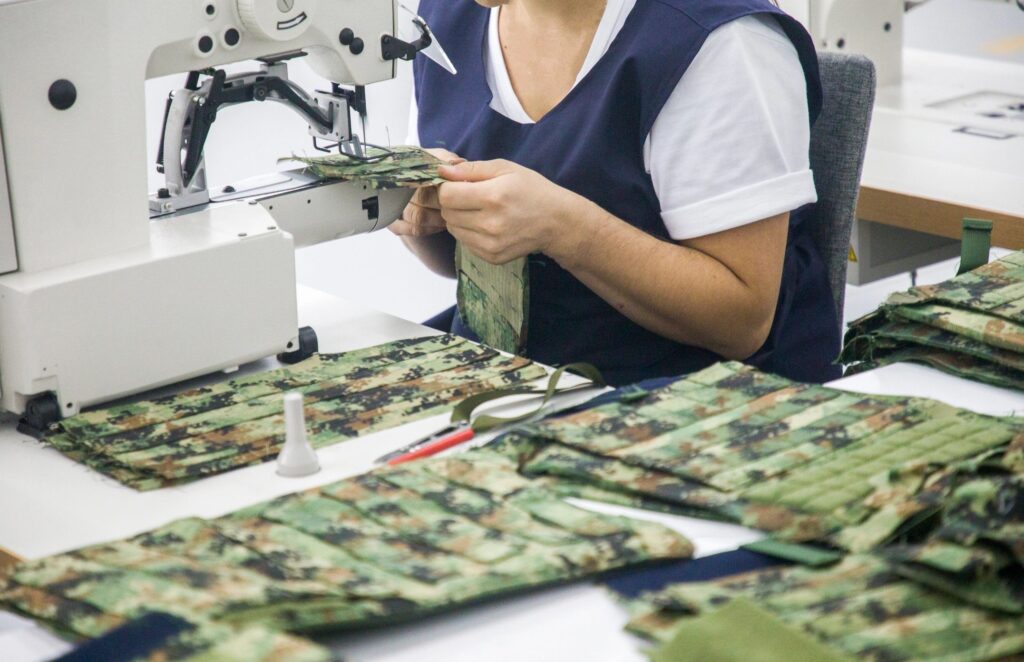 image-24 A person at a sewing machine working on custom marine fabrics.